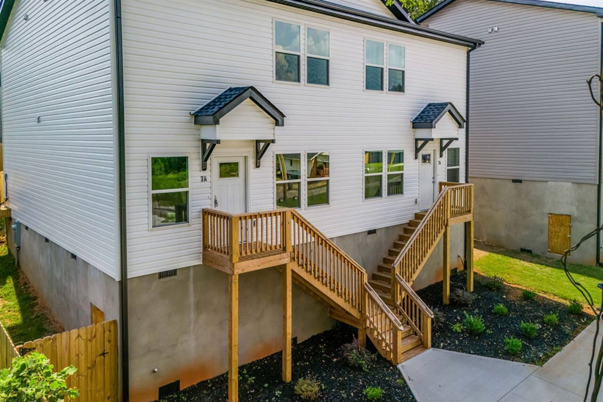 Welcoming entrance with a flight of stairs leading up to the front door, adding a touch of character to your arrival.