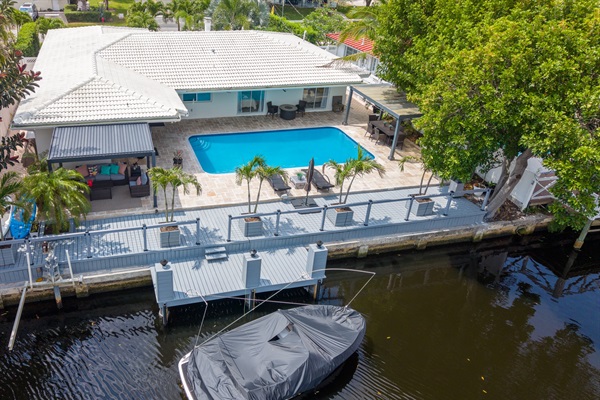 Aerial waterfront view with private dock & heated pool
