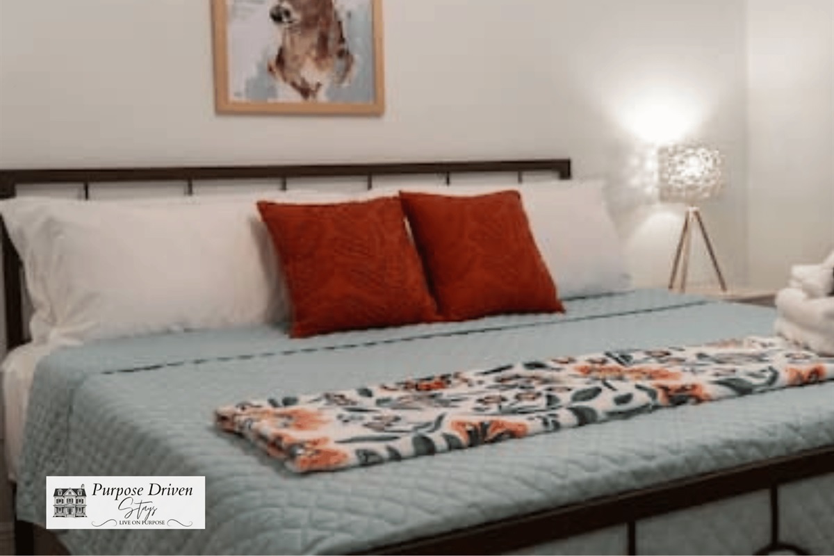 King bed in the main room with deer decor for our backyard friends!