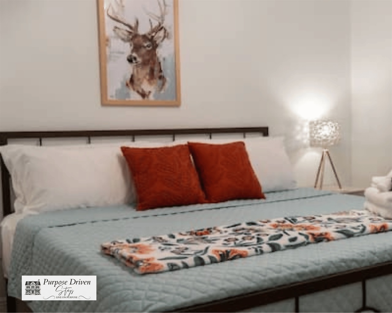 King bed in the main room with deer decor for our backyard friends!