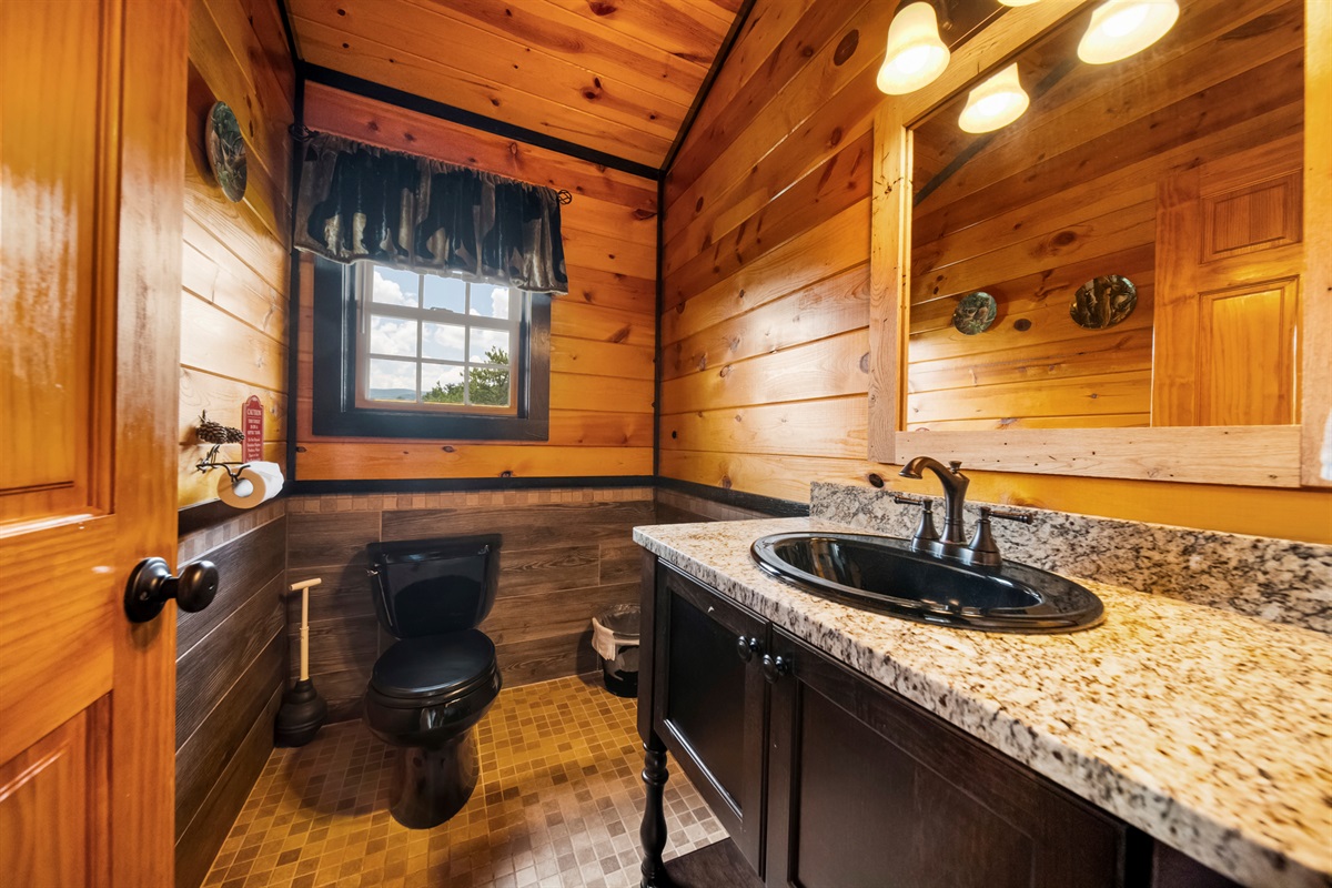 The convenient half bath is in the Great Room. Right in the middle of all of the action. It just has a toilet and sink, but it keeps your guests from using the master bath or having to run up and down the stairs to the big bathroom.