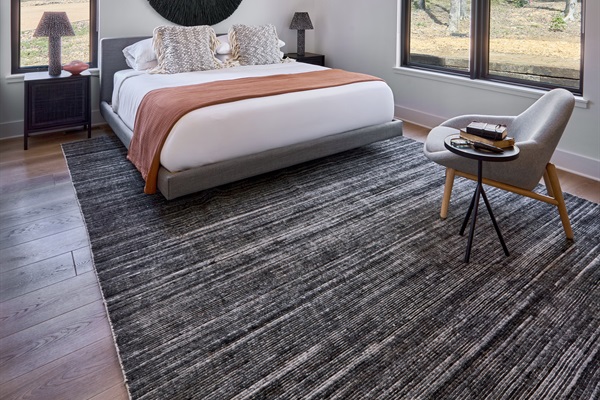 A king bedroom with woodland views and artistic flair, designed for rest, warmth, and style.