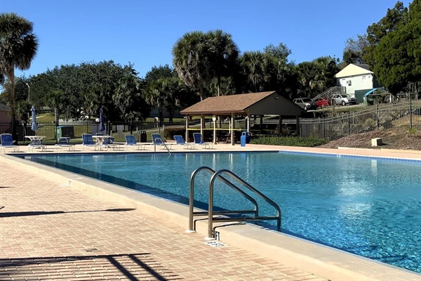 Recently resurfaced in December 2021, the HEATED Olympic-sized swimming pool is in pristine condition and has plenty of lounge chairs and a covered picnic/grill area.