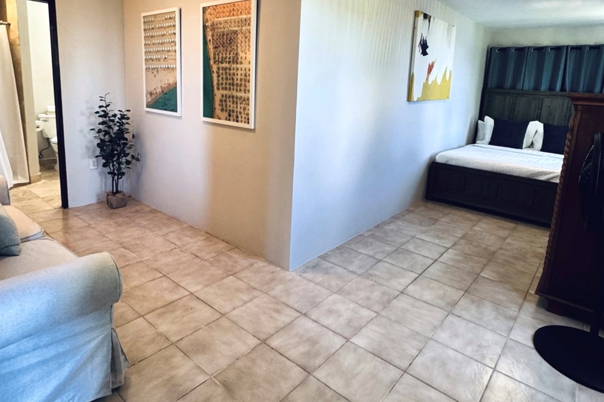 Suite Five is a whole vibe, with a seating area, queen bed and bathroom.