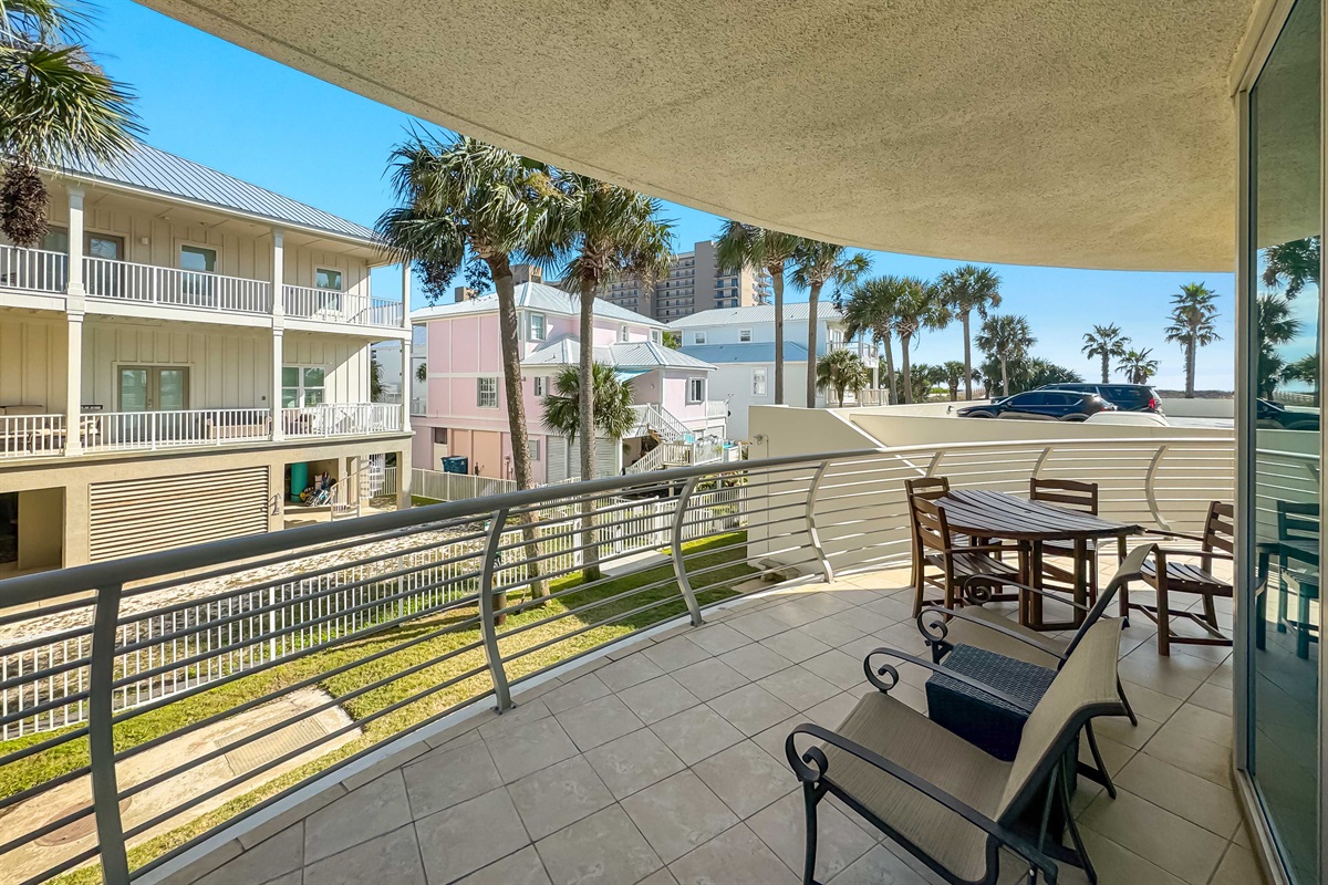 Integrating indoor comfort with outdoor space. This generously sized balcony, complete with elegant, classic patio furniture, extends the living area and offers captivating views.