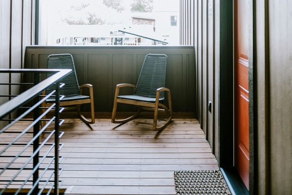 The upstairs walkway and shared sitting area at Gaines Ranch on the Square &mdash; quiet outdoor seating right beside the Lazy Spur Suite.