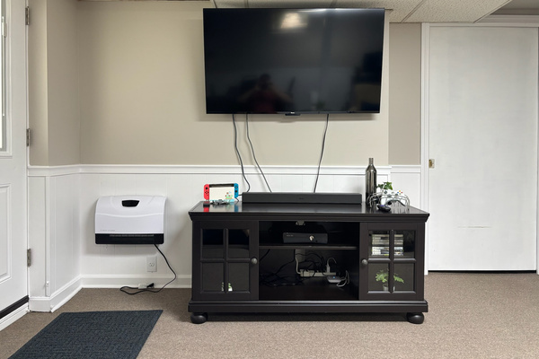 60" Game-room TV with an Xbox 360 and Nintendo Switch.