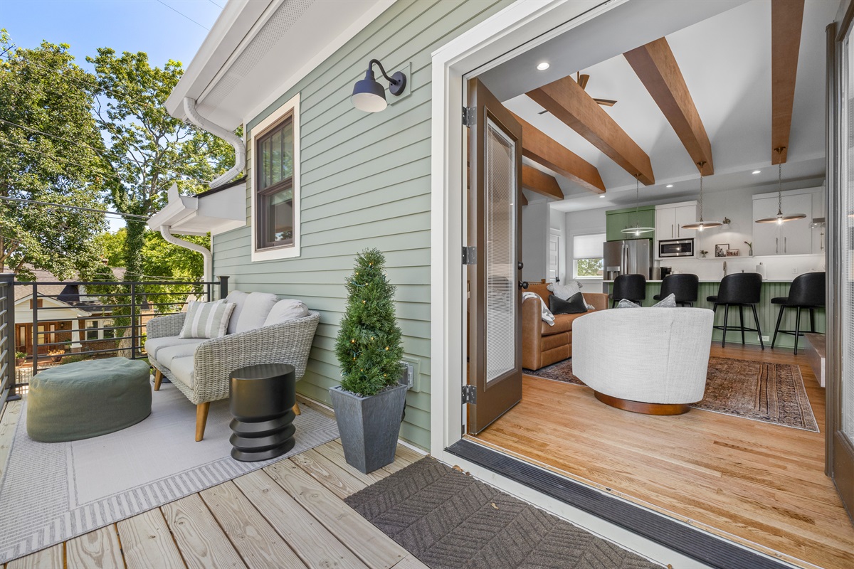 Indoor–outdoor flow with French doors opening from the living room to the balcony.
