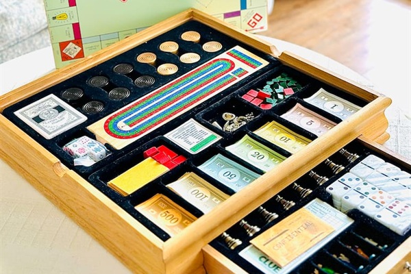 Combination board game set that includes Clue, Monopoly, checkers and Cribbage!