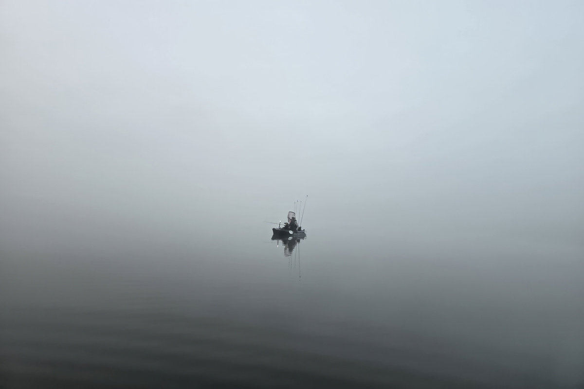 Before sunrise on Windfall Lake: mist hanging over the glass-calm water, kayak fishing for bass, pike, walleye, crappie, and perch, right from your backyard!