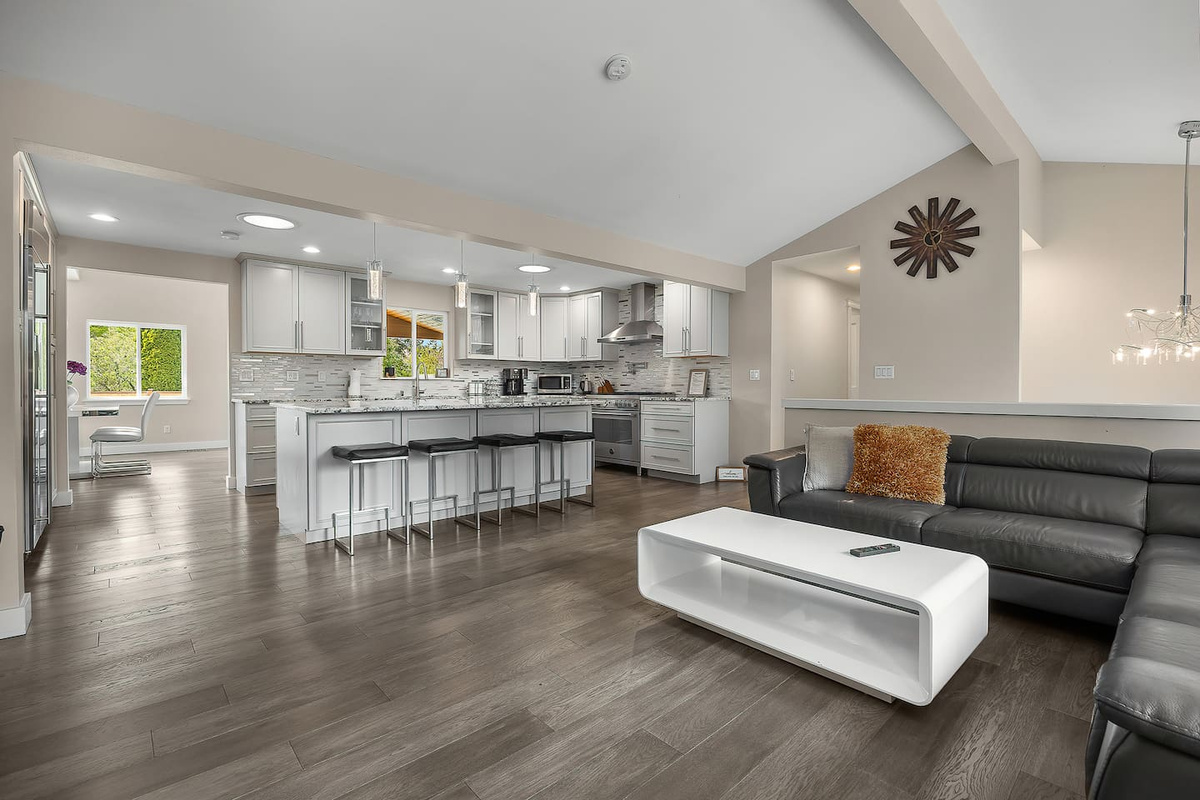 “This open-concept kitchen and living room creates a seamless flow, featuring high-end finishes, abundant natural light, and stylish furnishings—perfect for relaxing or entertaining.”