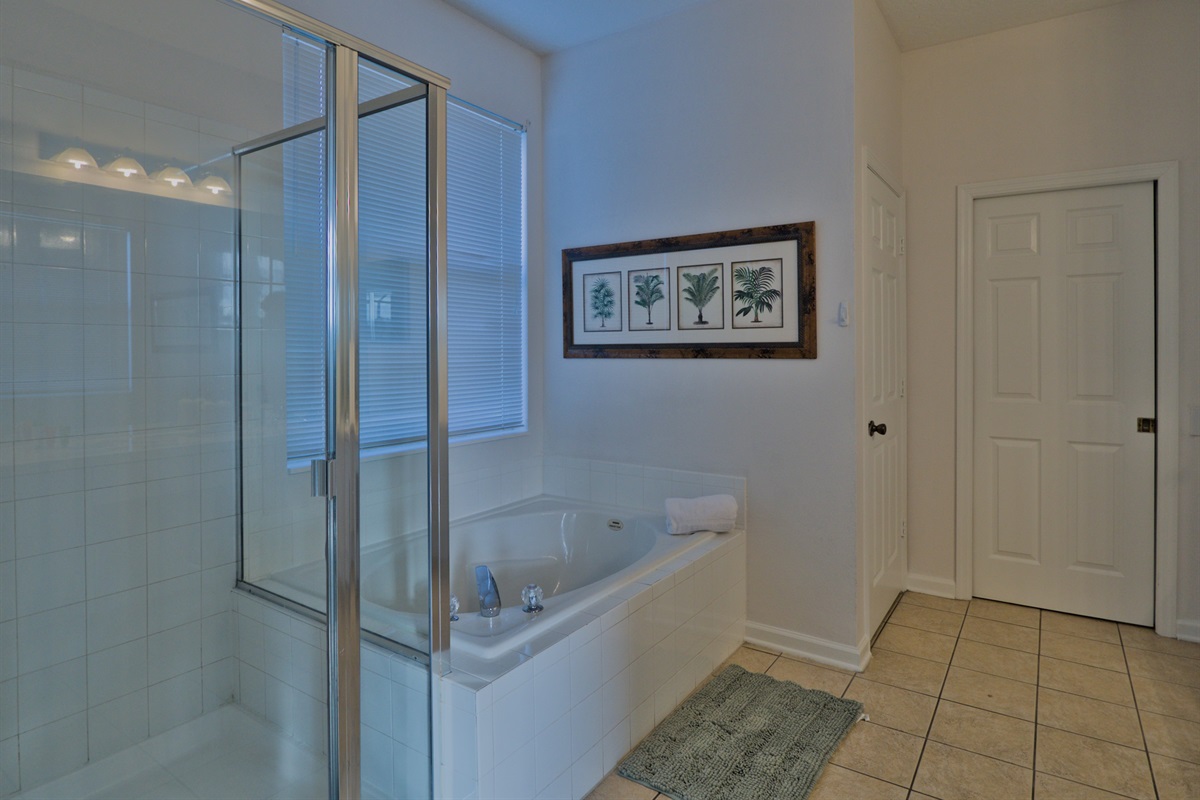 Jungle Book master bathroom with shower, tub, and two sinks.
