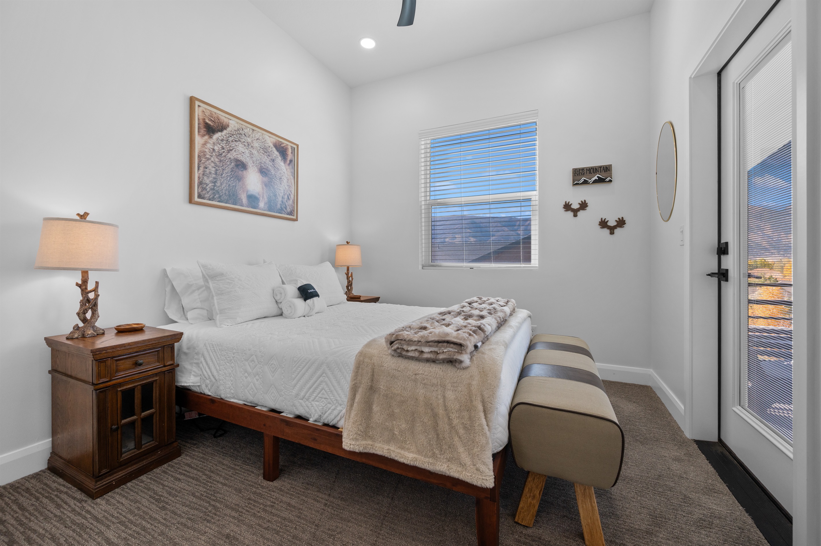 Upstairs guest bedroom with cozy queen bed and mountain views.