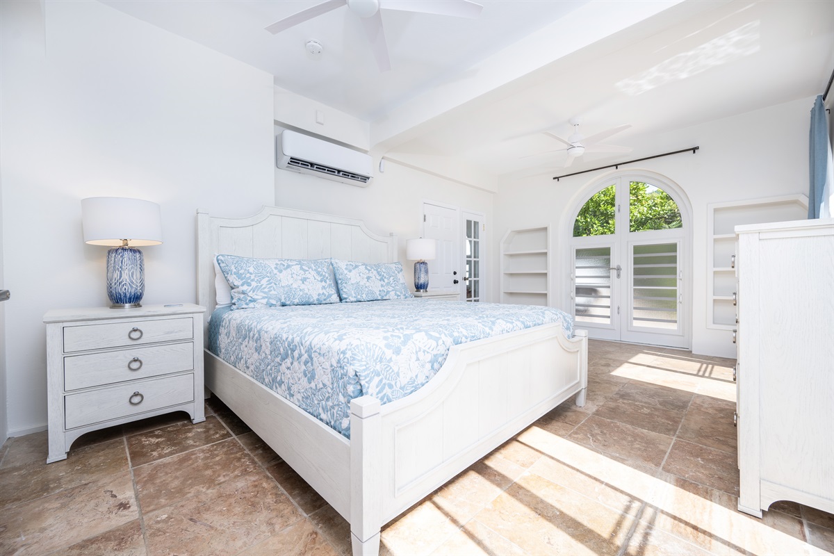 Downstairs Apartment Bedroom: Bright guest bedroom filled with natural light and sea breeze. There is an outdoor shower just off of the bedroom door in this photo.