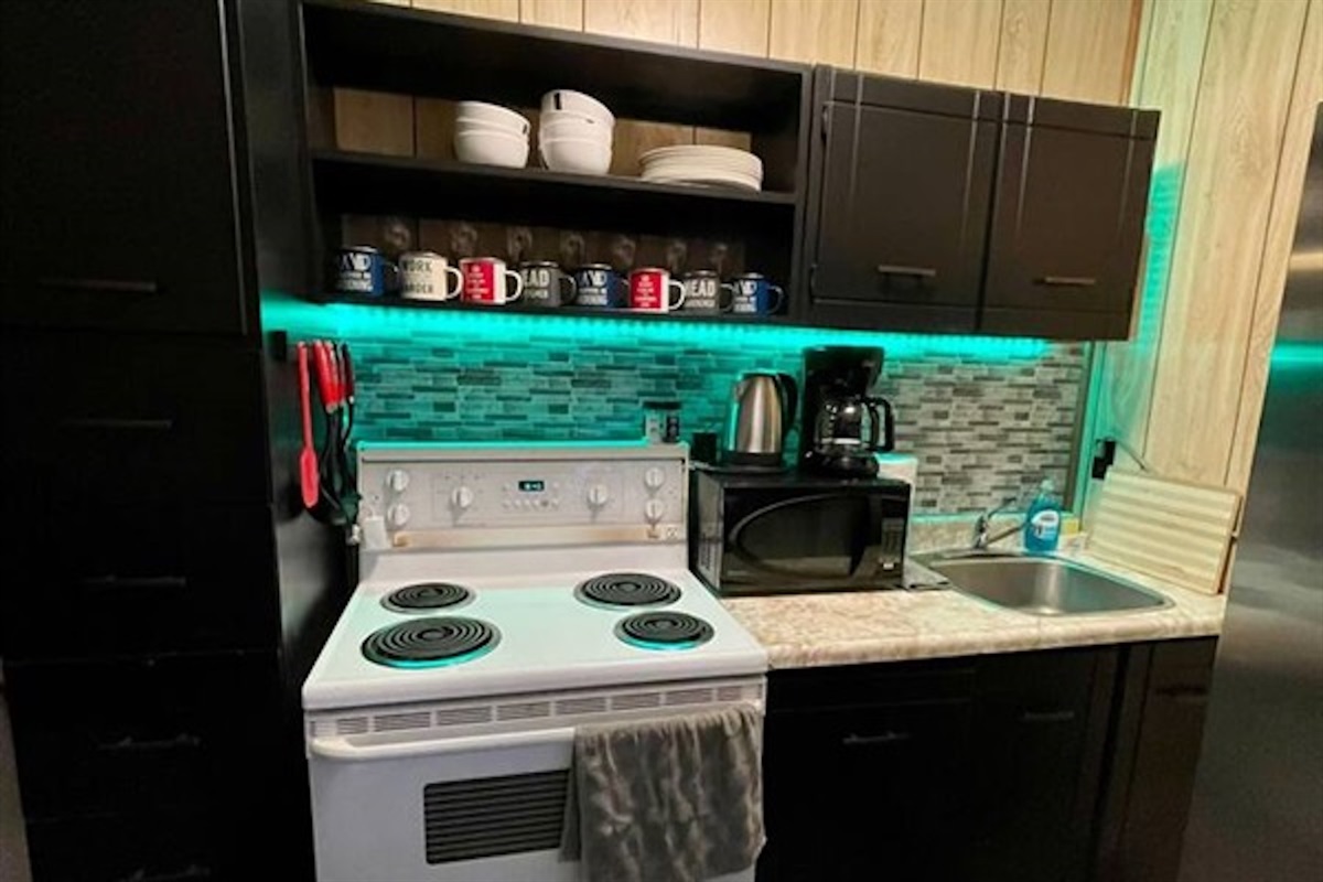 Compact kitchen with stove, storage and countertop workspace