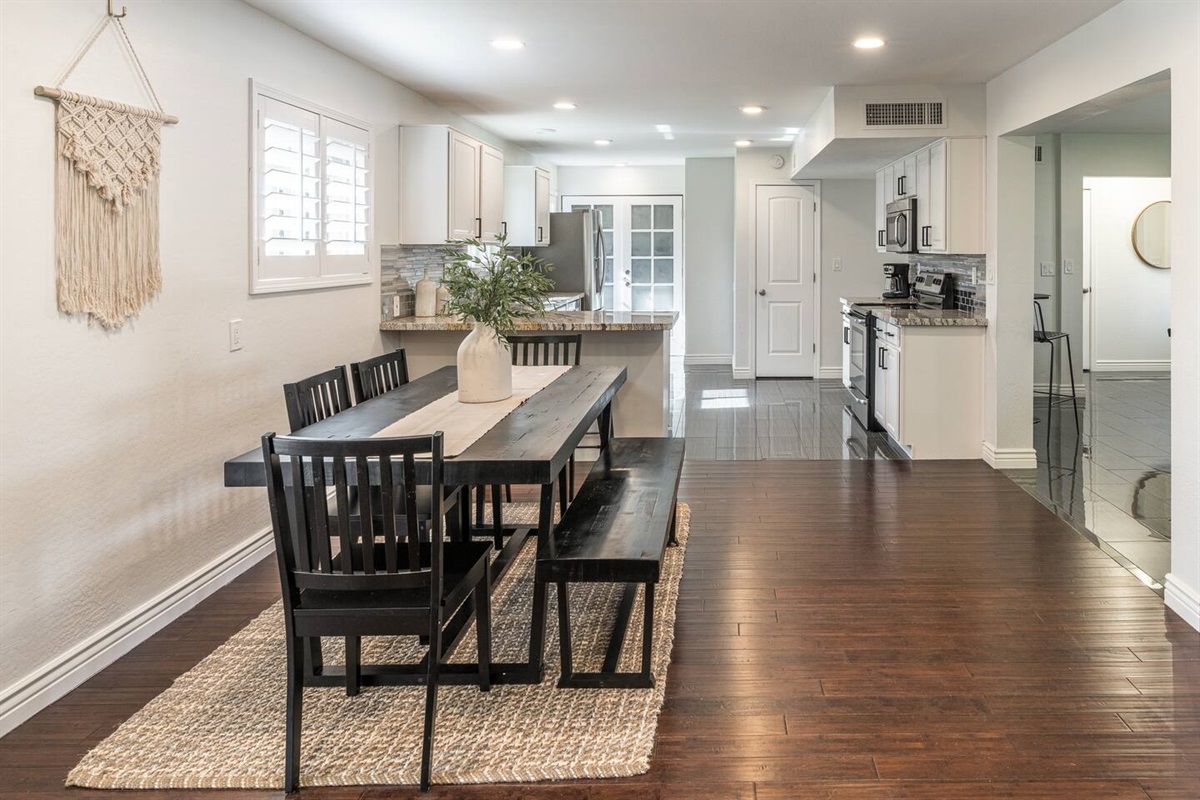 Large dining table and breakfast bar provide plenty of seating for meals.