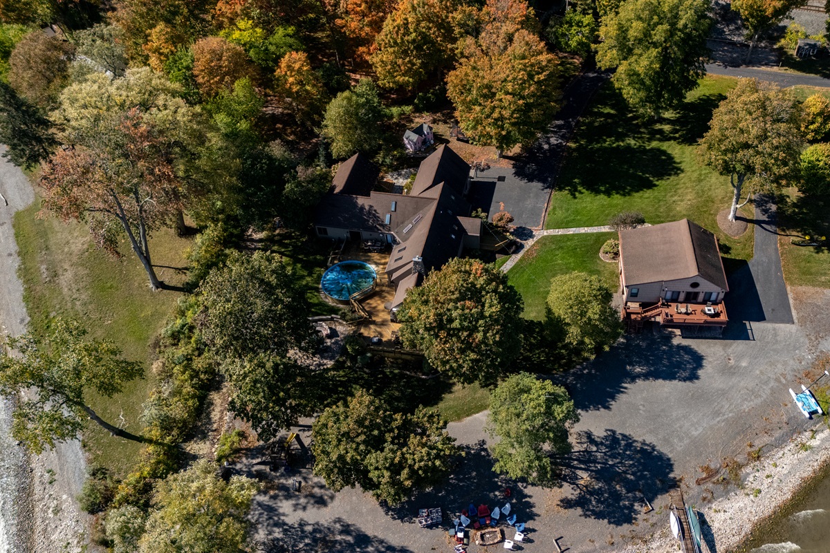 Stunning aerial view of a spacious Finger Lakes escape featuring beautiful landscaping and plenty of room to unwind.