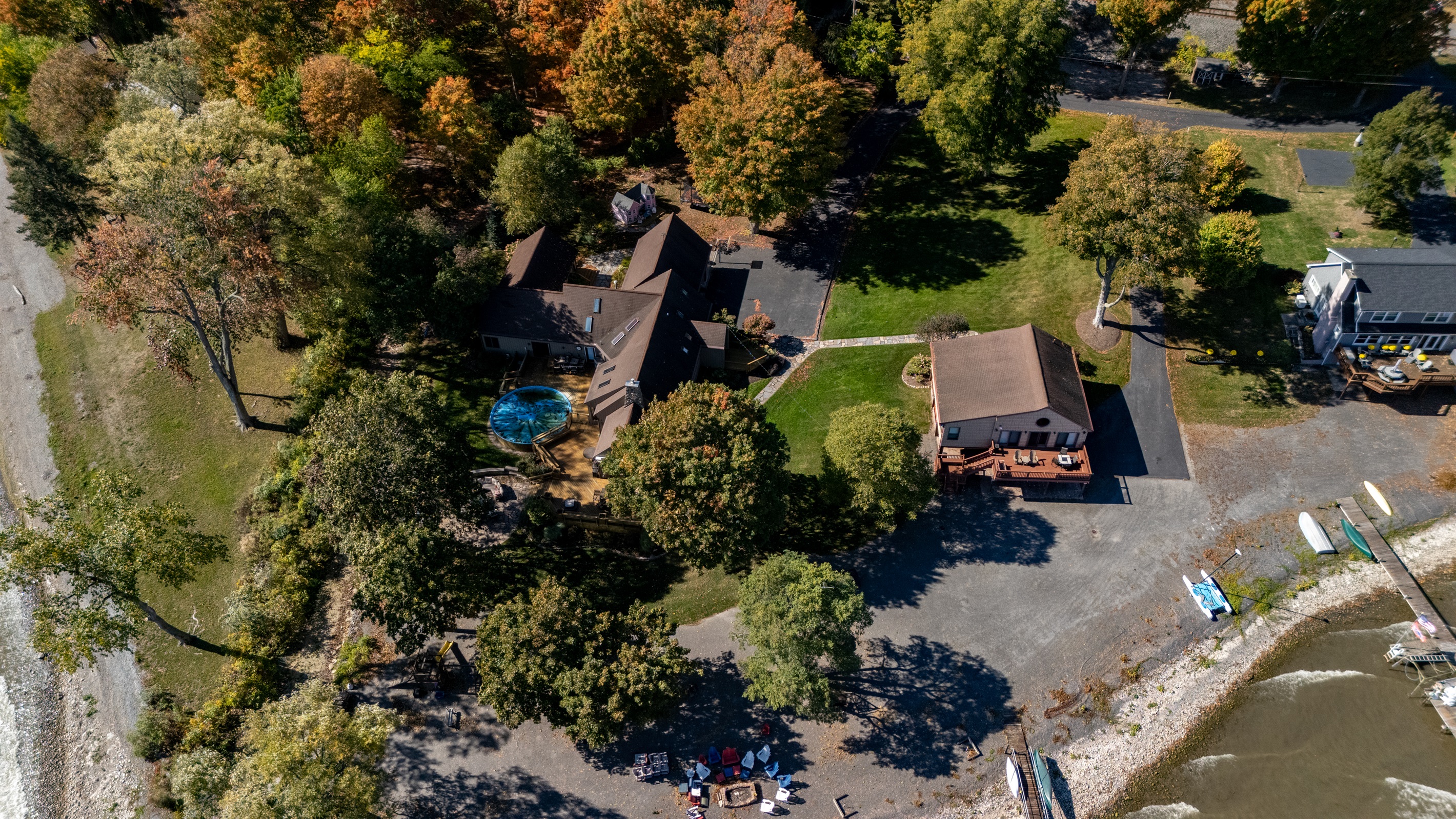 Stunning aerial view of a spacious Finger Lakes escape featuring beautiful landscaping and plenty of room to unwind.
