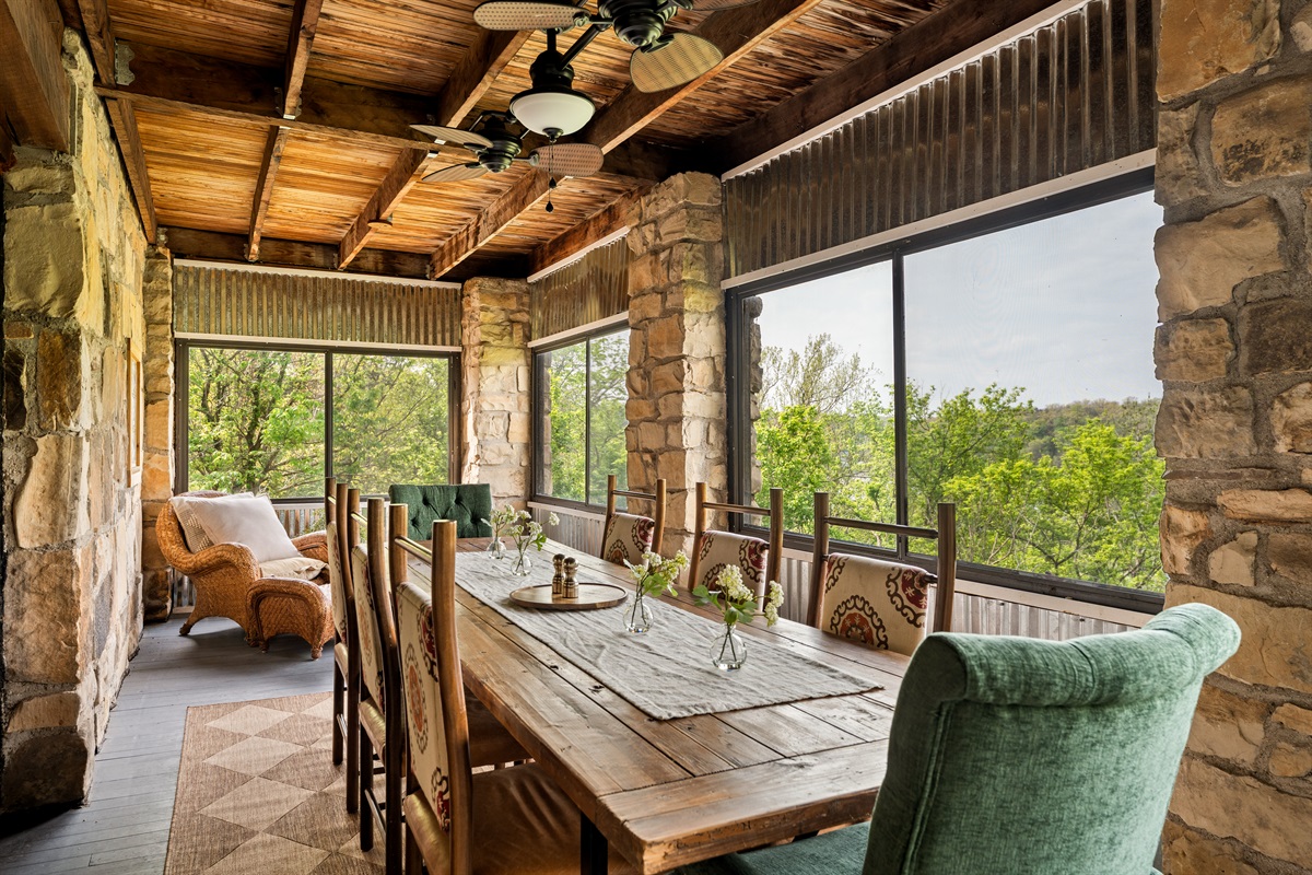 Dine surrounded by nature on the screened-in porch with seating for the whole group.