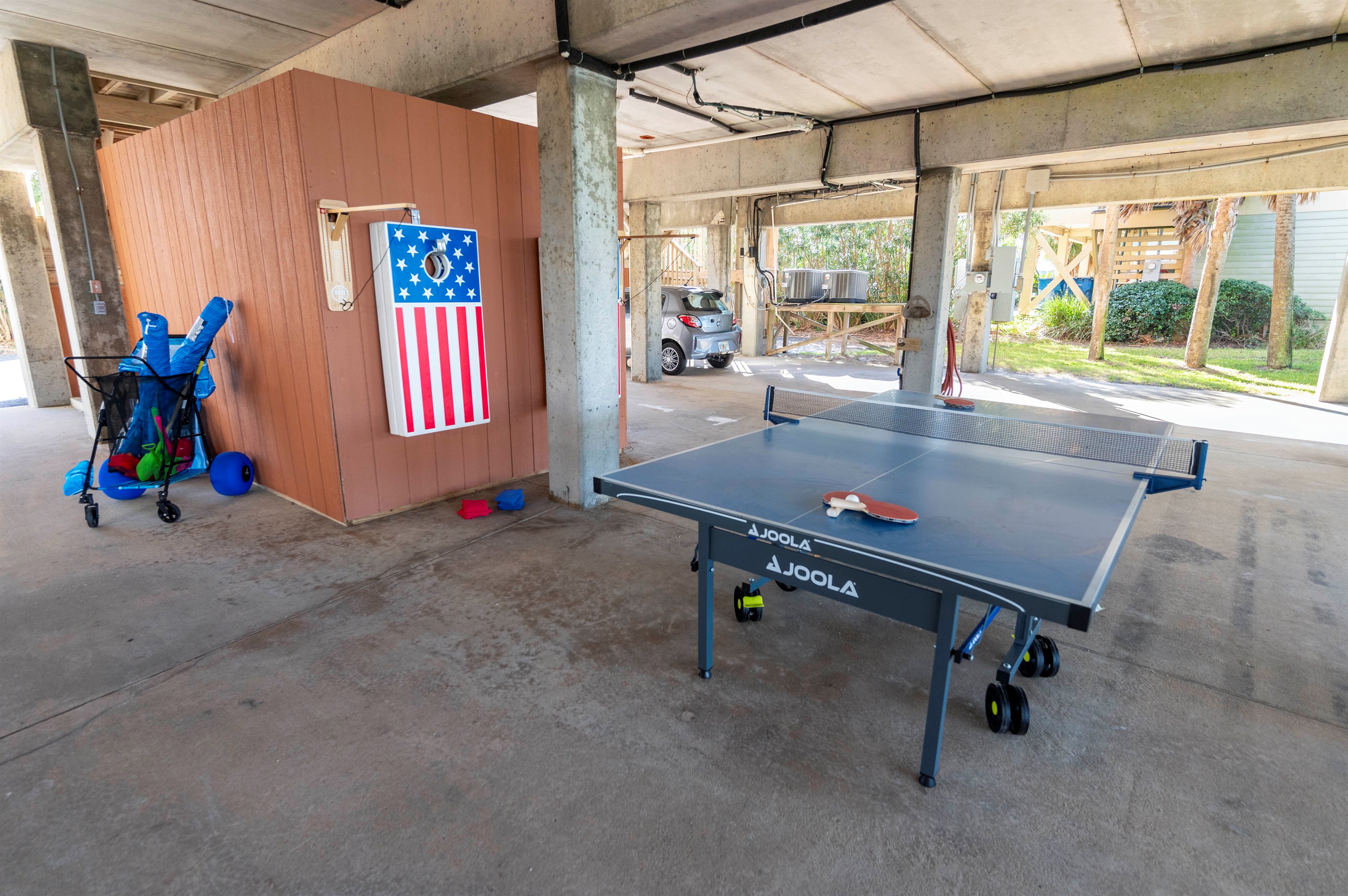 Fun-filled outdoor games corner with ping pong, cornhole, and endless joy!