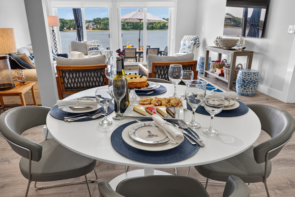 Gather around the dining table with beautiful views of the spacious living area and cozy fireplace.