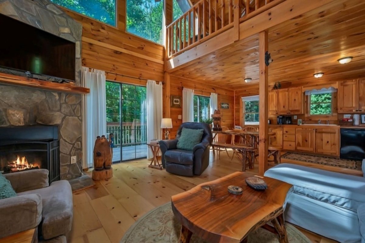 Large open log home living room with wood burning fire place