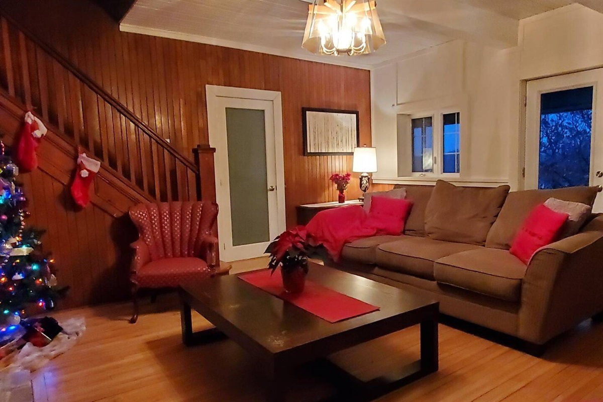 Living room seating area showing door to downstairs bathroom behind