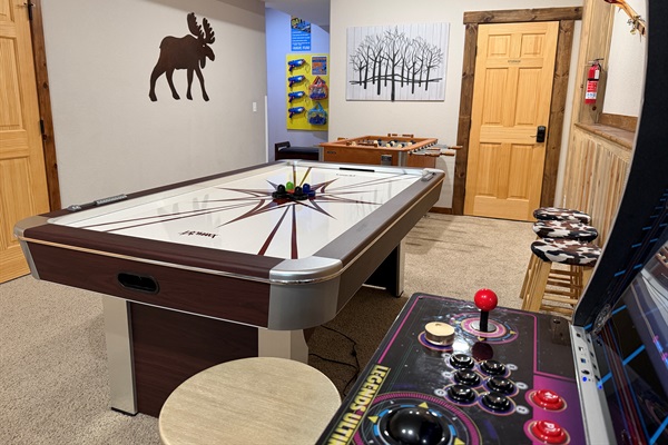 Endless fun awaits in our game room featuring air hockey, foosball, and a classic arcade! Perfect for family game nights.