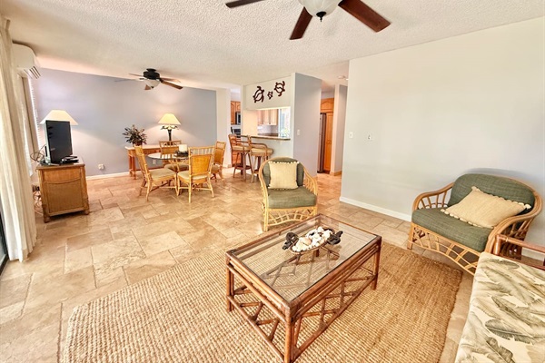 Roomy living room with sleeper sofa (queen) couch, 2 chairs, television and opens to the lanai.