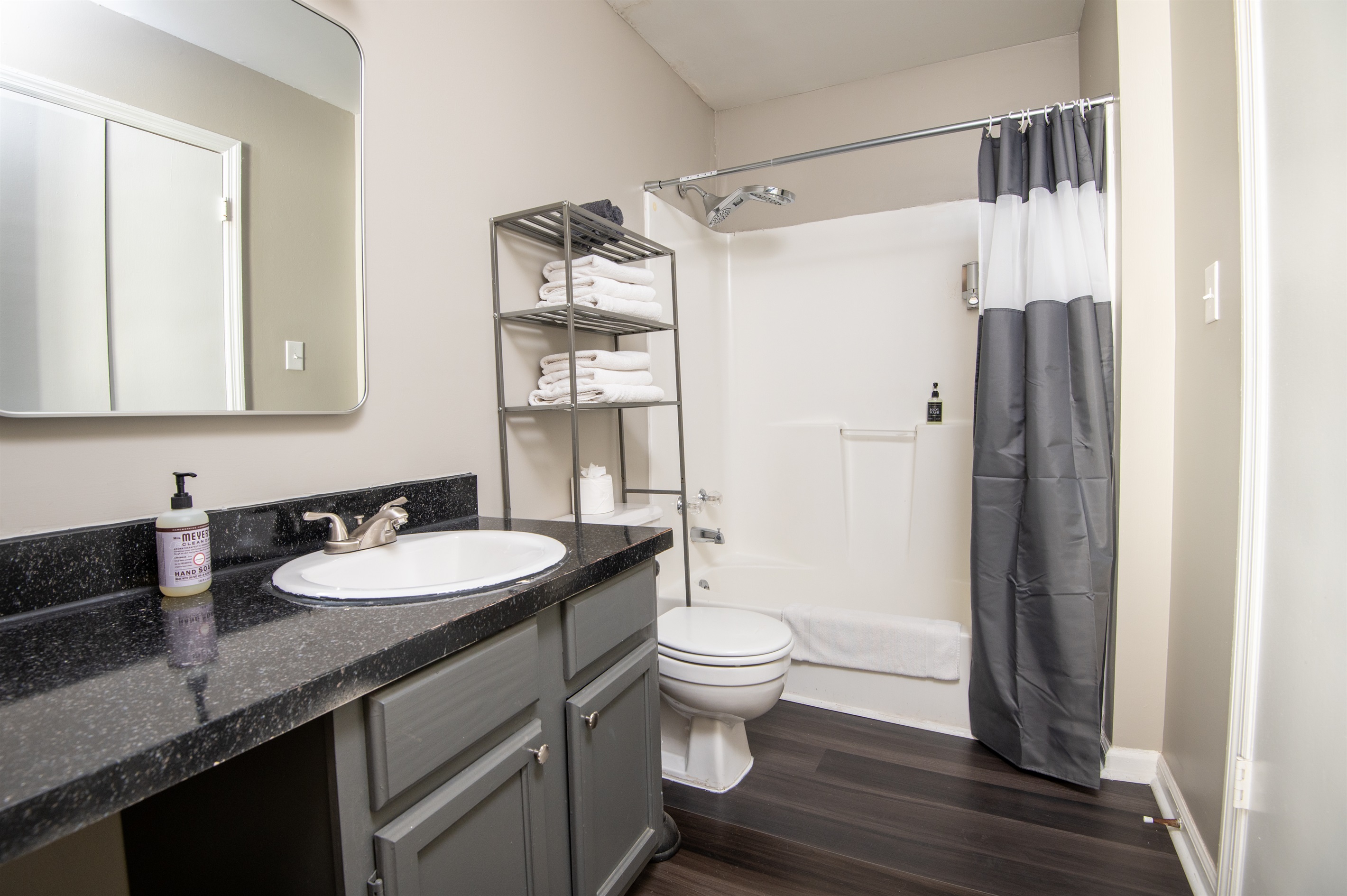 This ensuite bathroom in Unit B comes complete with shampoo, body wash, conditioner, hand soap, and all the linens you need for a comfy stay.