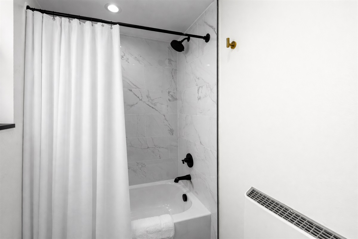 Clean, spa-inspired shower with modern fixtures, soft lighting, and a fresh, minimalist design—perfect for unwinding after a long day.
