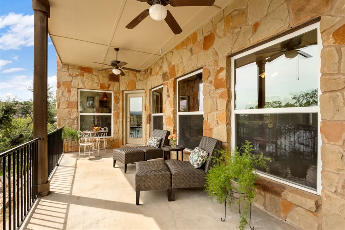 Main porch with bistro set and lounge chairs