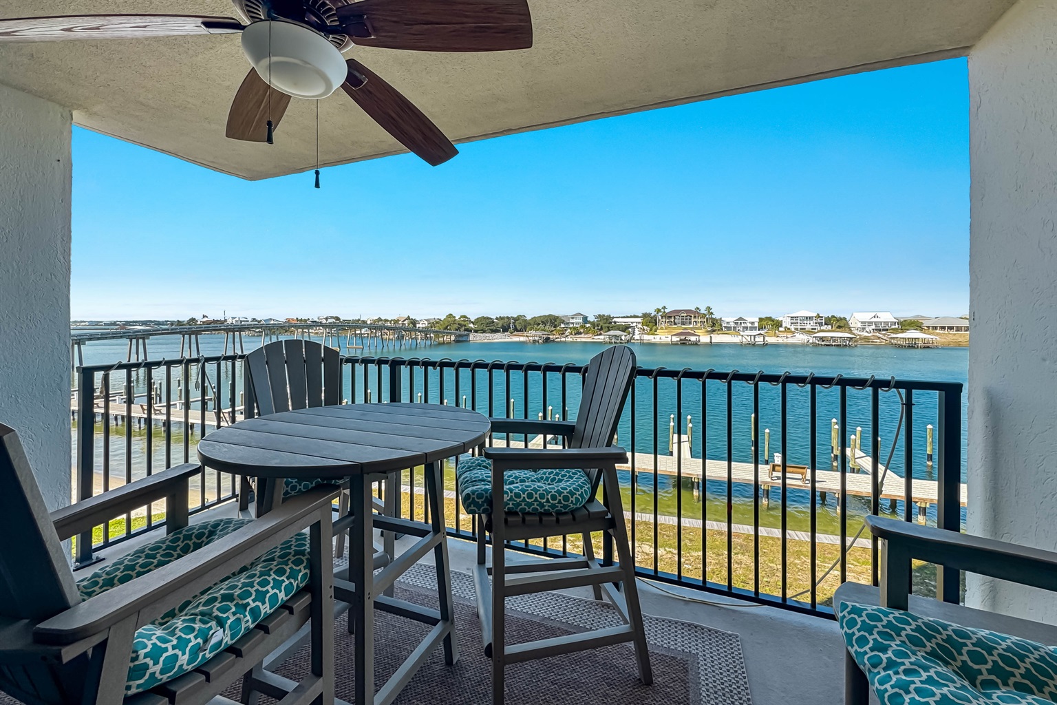 Wake up to this view every morning! Enjoy your morning coffee or an evening cocktail on the private balcony overlooking the pristine bay. Featuring comfortable, high-top seating and a ceiling fan for year-round enjoyment.