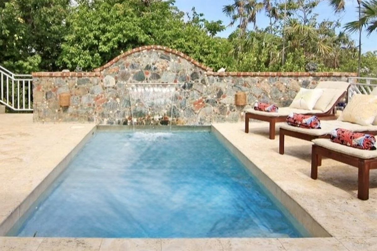 Spacious pool deck with sun loungers and tropical greenery—perfect for all-day lounging and dips.