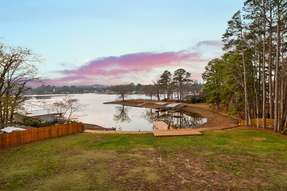 Lake views framed by trees create a peaceful backdrop just outside the home.