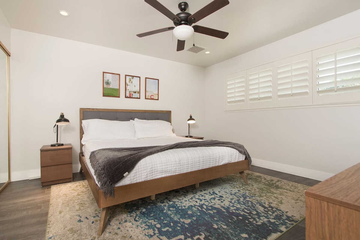 Primary bedroom with King sized bed and attached ensuite and full body length mirror
