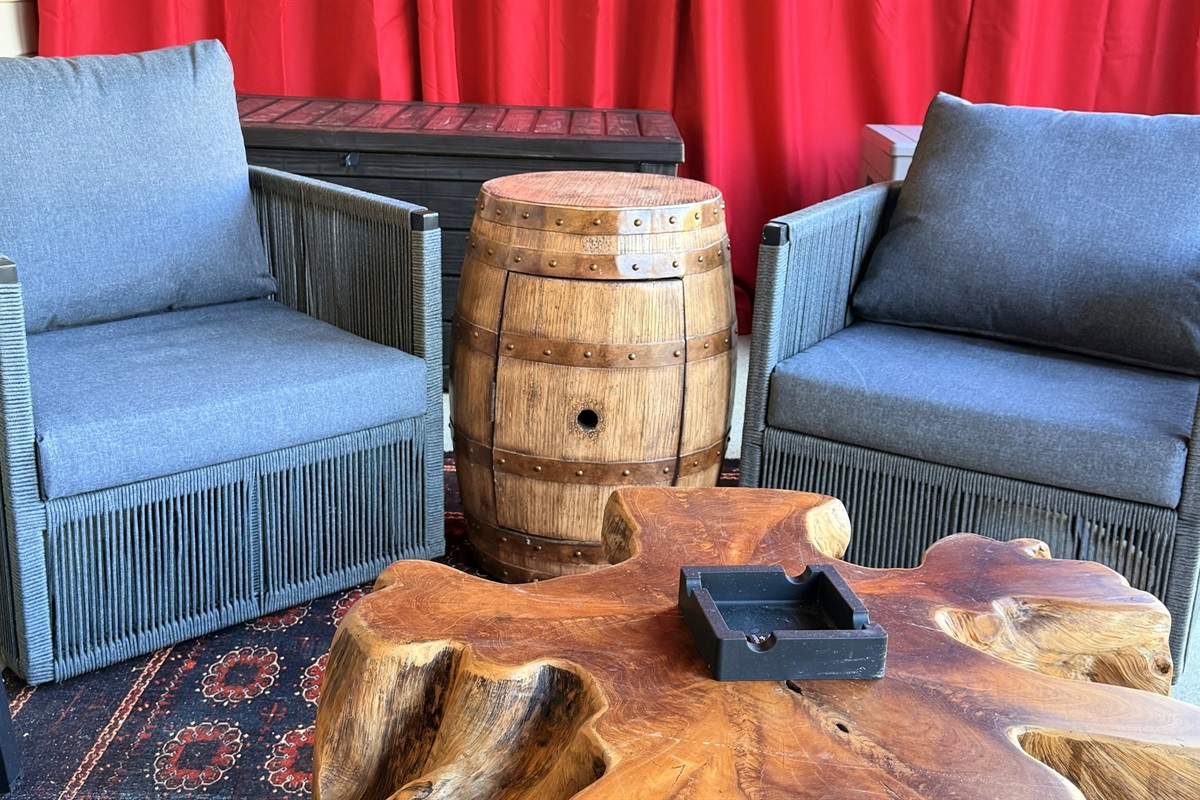 A quiet corner for conversation — rich wood, bourbon-barrel charm, and a hint of old-world leisure invite guests to slow down and savor the moment.