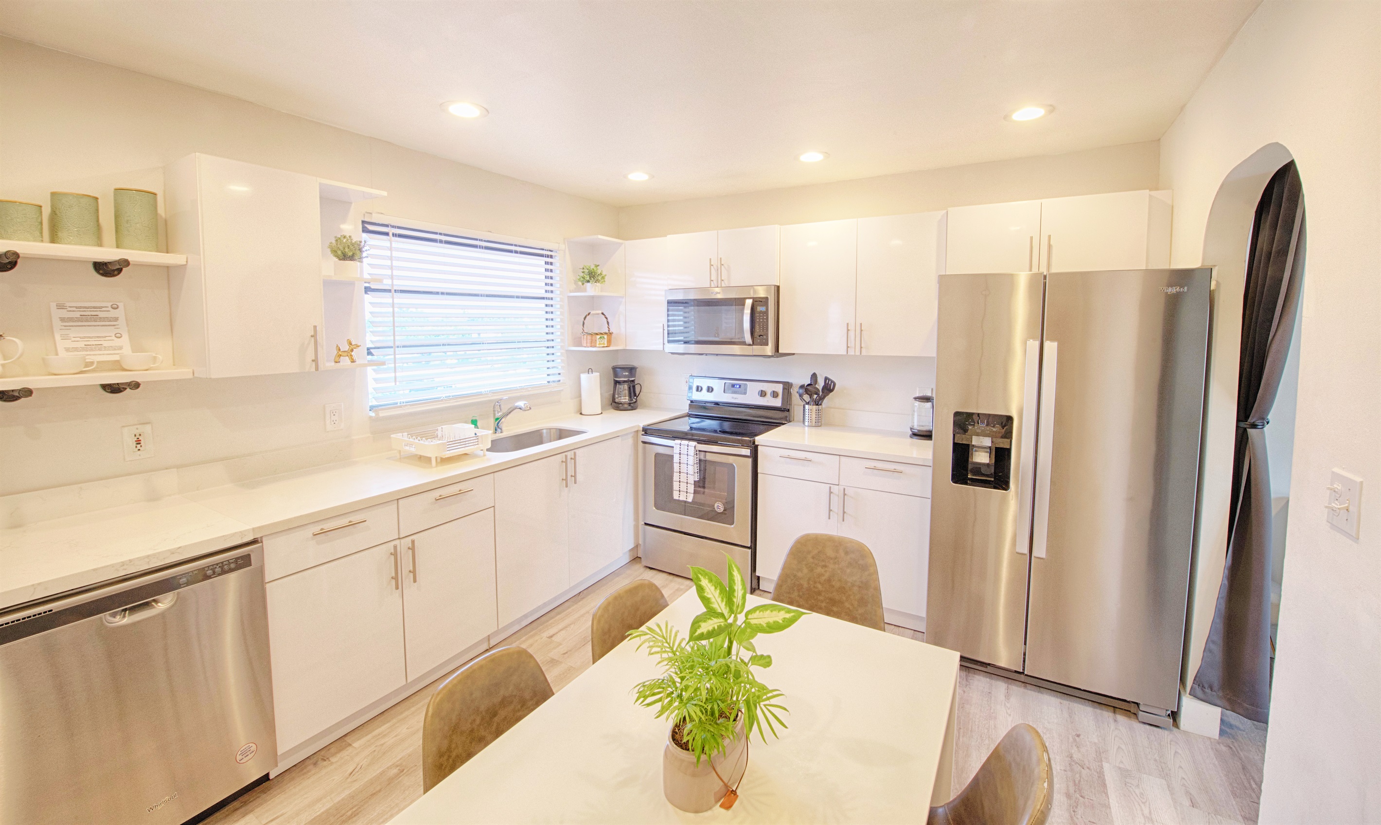 Featuring stainless steel dishwasher, stove, and large fridge with automatic ice maker and filtered water dispenser.