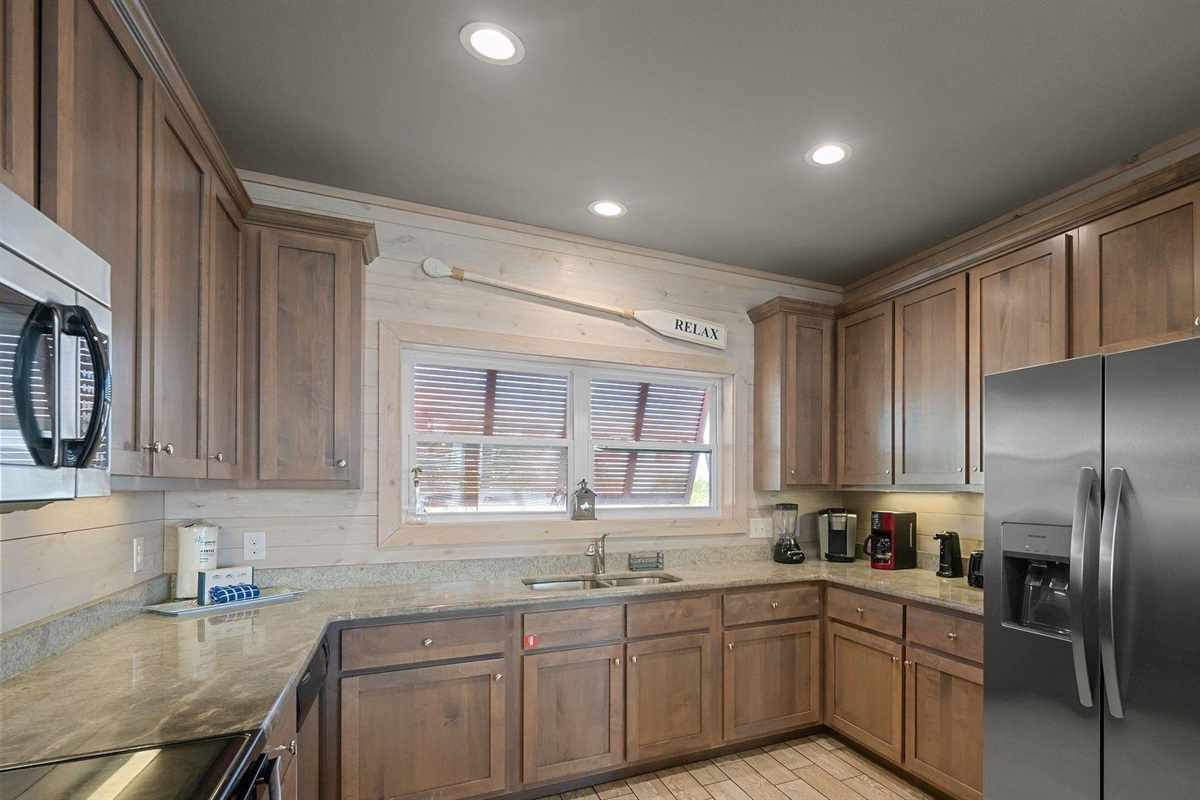 Fully stocked kitchen with stainless steel appliances, granite tops and beautiful view! 