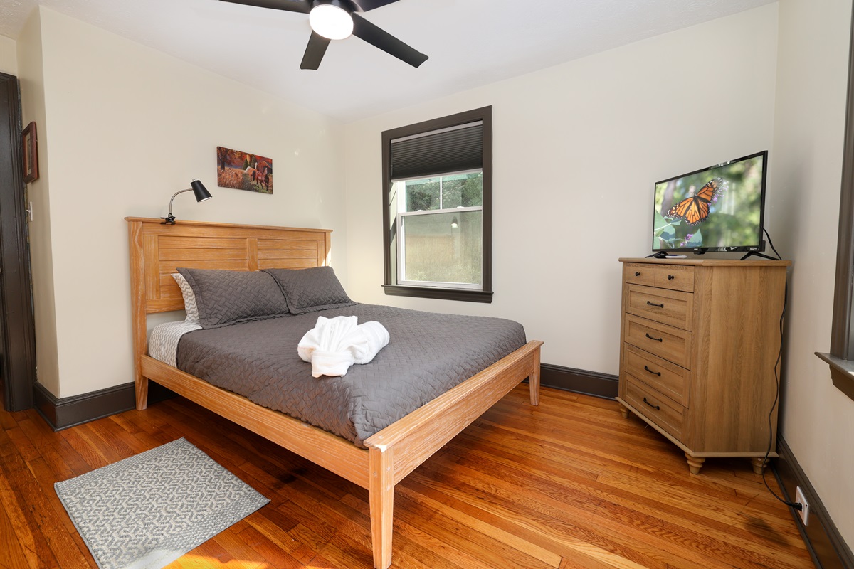 Bedroom with queen bed and Roku TV