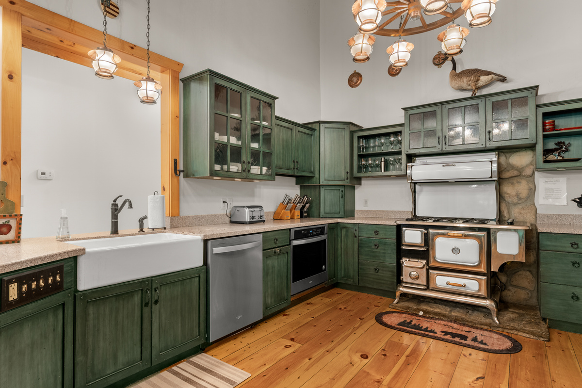 Kitchen with two refrigerators, stove, oven, gas oven, and dishwasher.