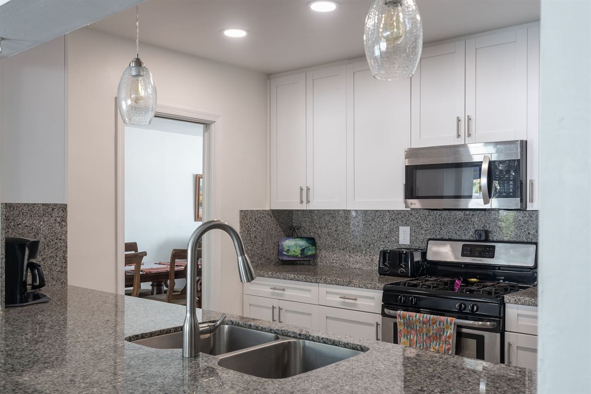 Gorgeous modern kitchen features state-of-the-art appliances. The open breakfastbar/kitchen area is a design element that brings family and friends together to sharequality time, conversation, and meal preparation.