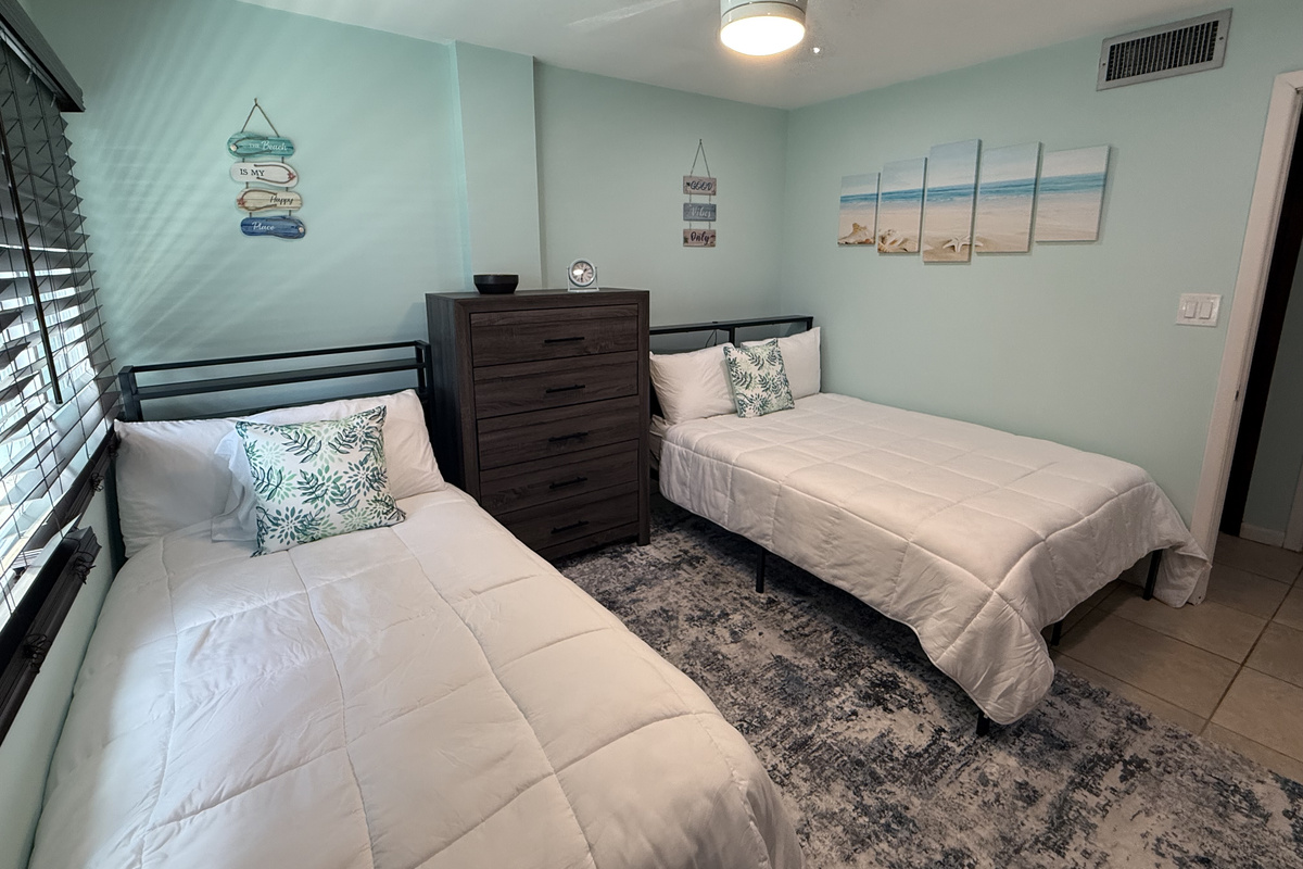 The perfect spot for families or a couple in this guest bedroom with a double and twin bed.