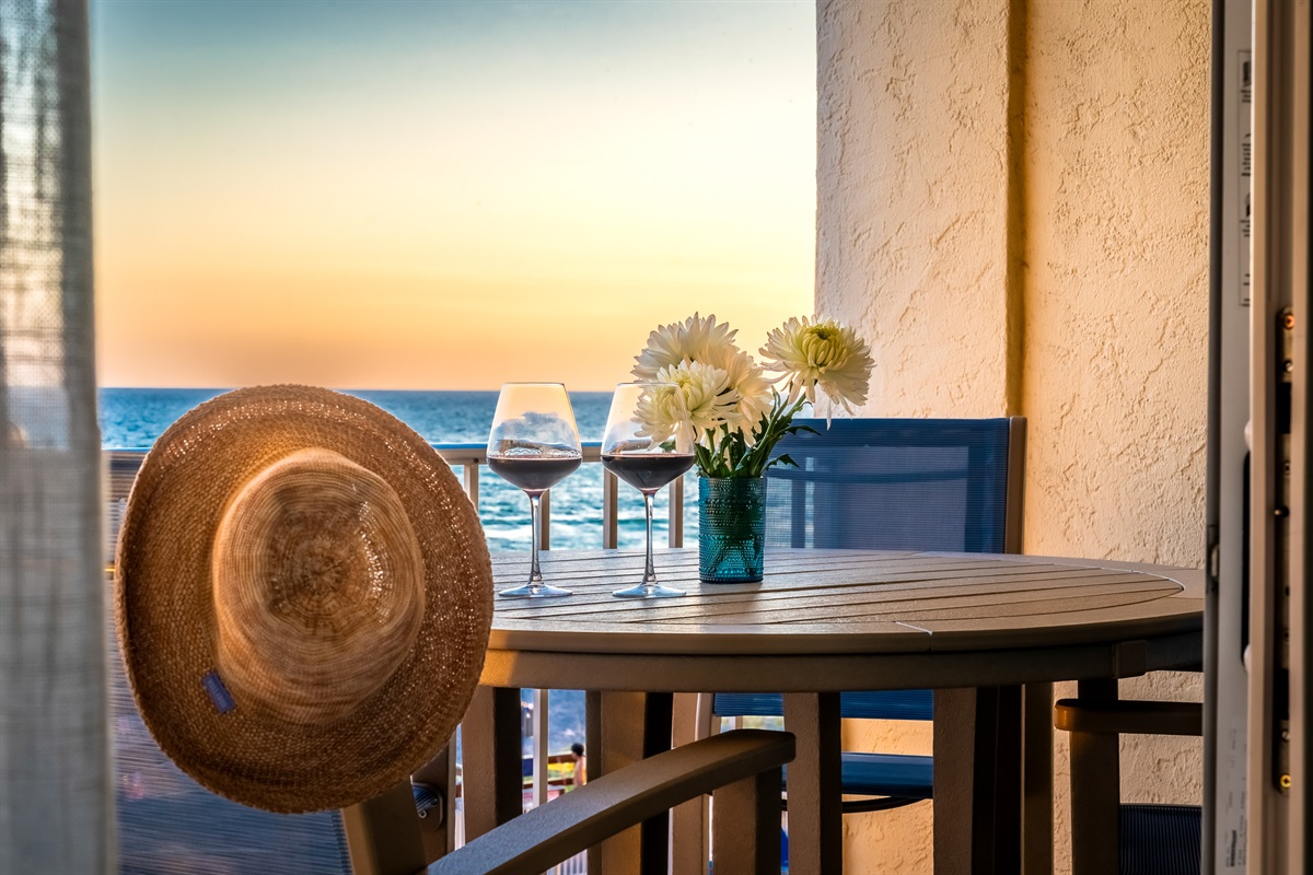 Breathe in the salty Gulf breeze as you sip wine at sunset, watching the sky melt into shades of orange and pink from your private balcony table.