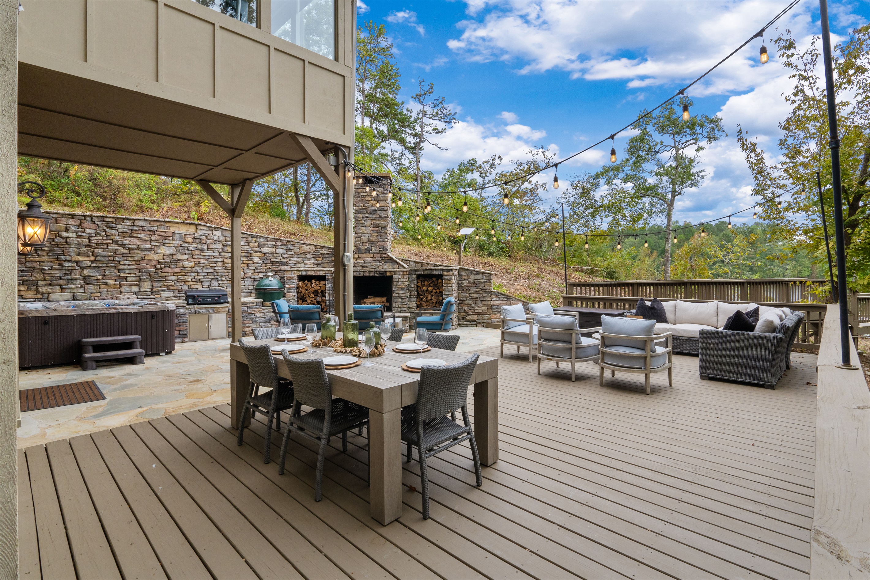 Relax outdoors with dining space, a soothing hot tub, and comfortable seating around the fireplace—perfect for evening meals, quiet soaks, and cozy nights under the stars.