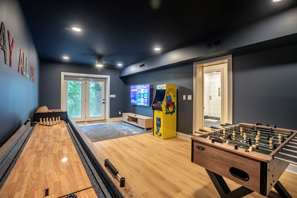Game room with shuffle board table, foosball, arcade game, large screen tv, and more! Perfect for all ages. 