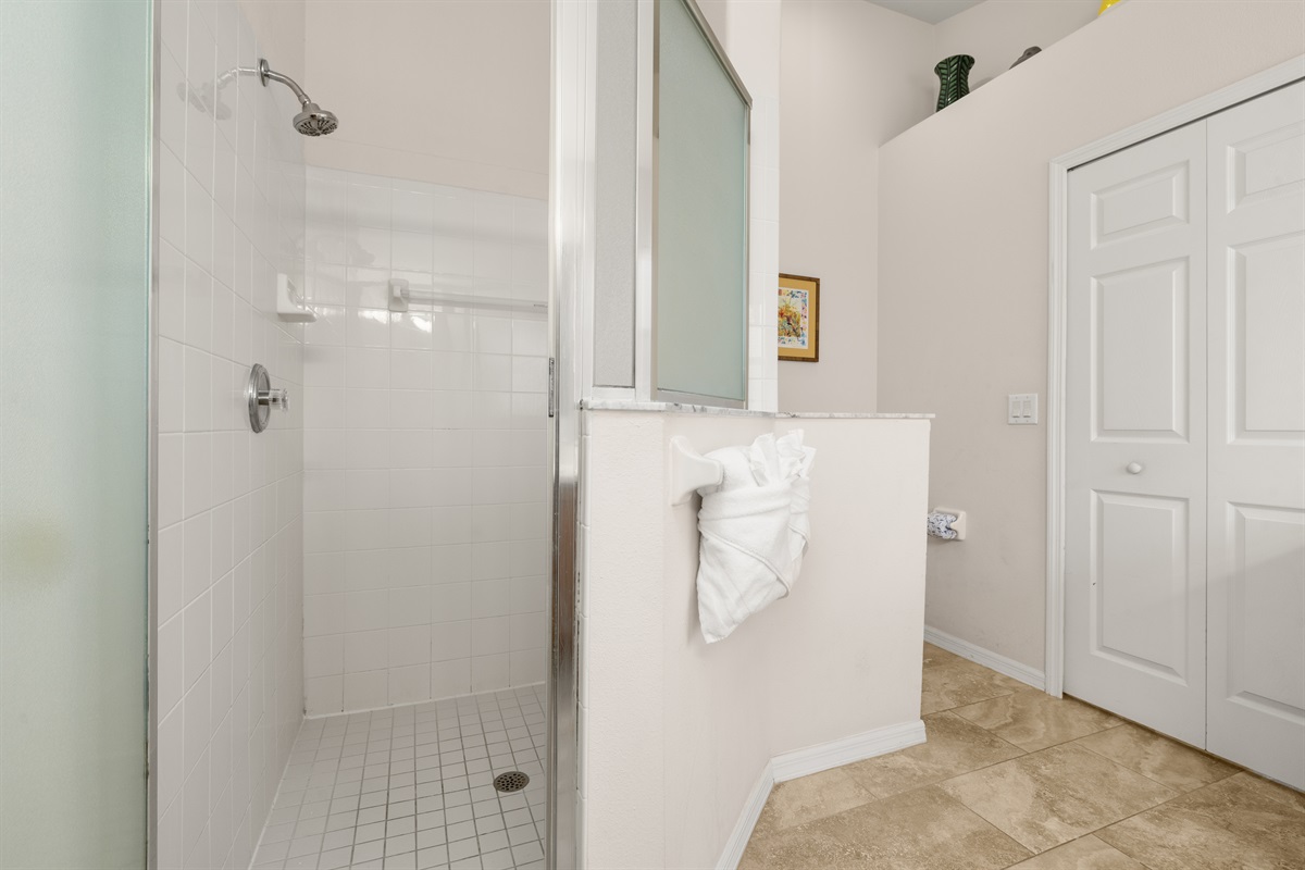 Opposite the huge, garden tub and sinks, is the large, walk-in shower stall.
