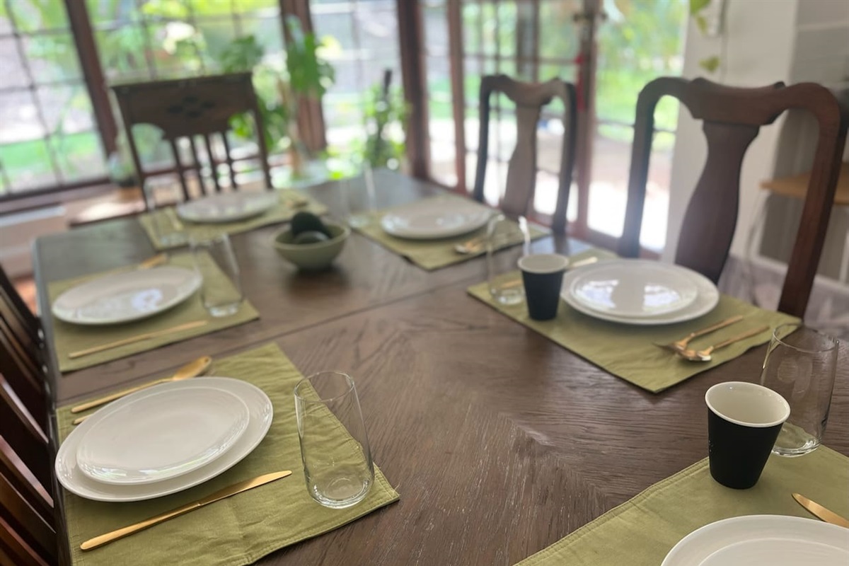 Relaxed family dining table, next to kitchen,  with views and access to yard and verandas. Beautiful timber screened door lets the breezes in…