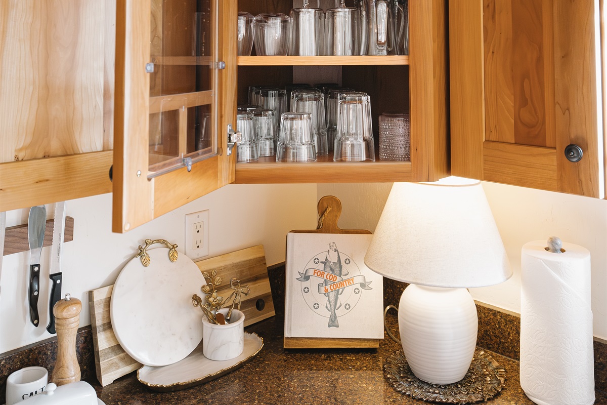 Fully stocked kitchen with glassware for every occasion—wine glasses, tumblers, and bar essentials ready for cozy nights in or relaxed dinners at Attiwood Ridge.