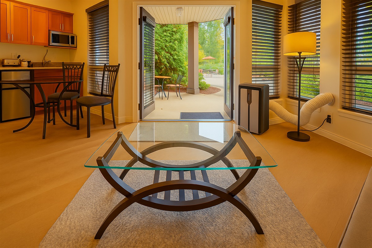 Unit B Double glass doors opening to Covered patio with outdoor seating in Unit B. AC Unit for seasonal comfort.